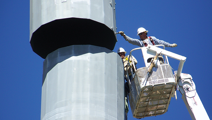 workers in bucket lift at Clear Springs to Hutto Transmission Line construction site